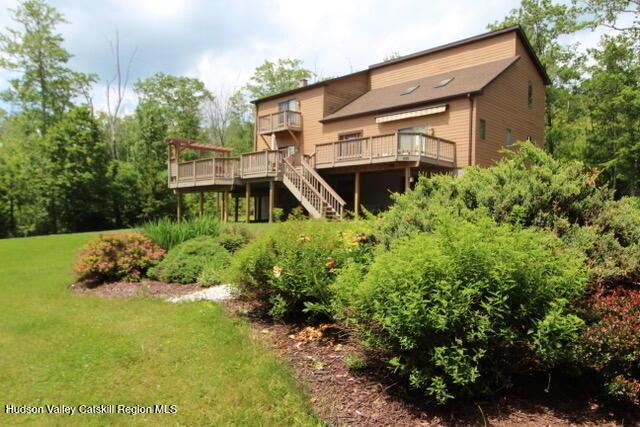 213 Botti Dr, Hunter, NY 12442 - back of property featuring a wooden deck, stairway, and a lawn