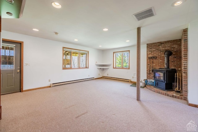 213 Botti Dr, Hunter, NY 12442 - unfurnished living room featuring baseboard heating, a wood stove, carpet, and recessed lighting
