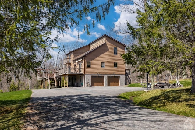 213 Botti Dr, Hunter, NY 12442 - view of side of home featuring stairway, driveway, a garage, a deck, and a lawn