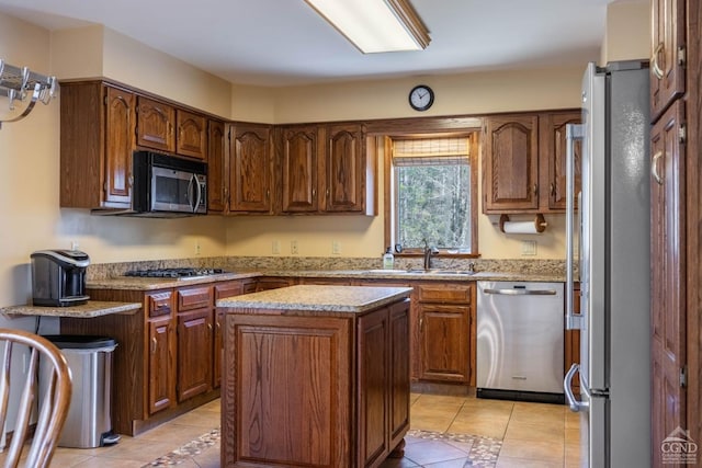 213 Botti Dr, Hunter, NY 12442 - kitchen featuring stainless steel appliances, light tile patterned floors, a center island, light stone counters, and brown cabinets