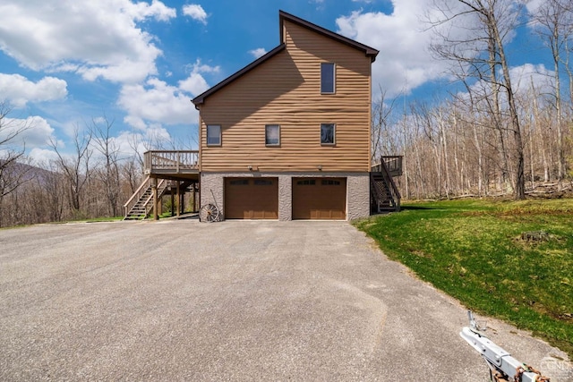 213 Botti Dr, Hunter, NY 12442 - view of property exterior with stairway, asphalt driveway, an attached garage, a yard, and a wooden deck