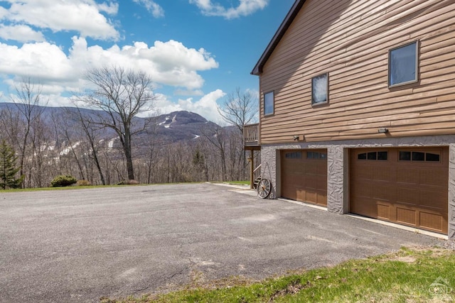 213 Botti Dr, Hunter, NY 12442 - view of side of property with a mountain view, a garage, and asphalt driveway