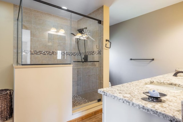 213 Botti Dr, Hunter, NY 12442 - full bath featuring vanity, a tile shower, and wood finished floors