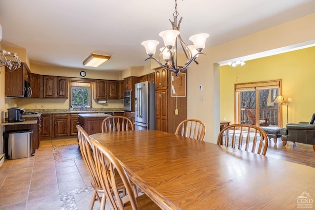 213 Botti Dr, Hunter, NY 12442 - dining room with a chandelier and light tile patterned flooring