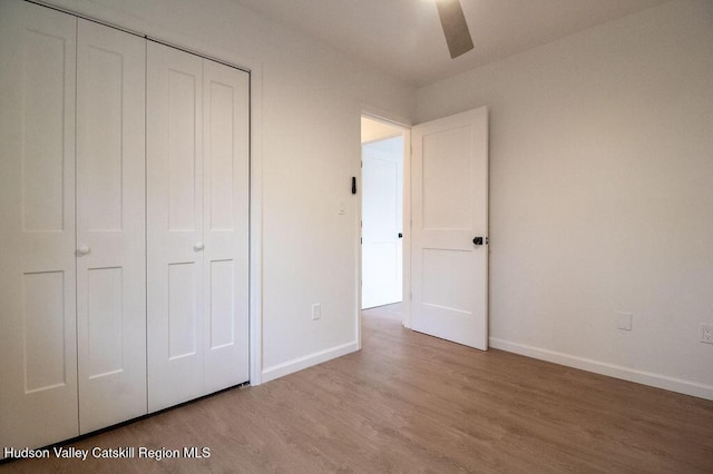 11 Old Farm Rd, Napanoch, NY 12458 - unfurnished bedroom with wood finished floors, ceiling fan, baseboards, and a closet