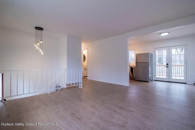 11 Old Farm Rd, Napanoch, NY 12458 - unfurnished living room featuring french doors, wood finished floors, and baseboards