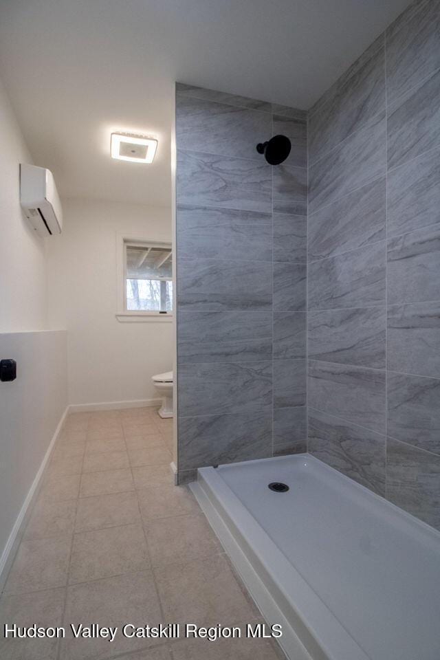 11 Old Farm Rd, Napanoch, NY 12458 - full bath with a tile shower, toilet, tile patterned floors, a wall mounted air conditioner, and baseboards