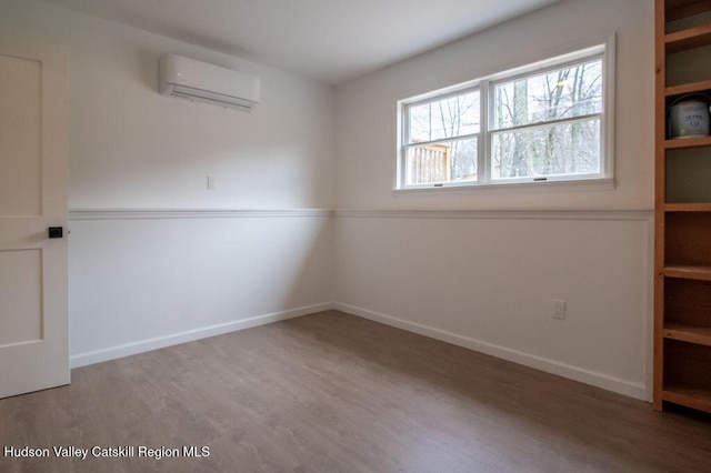 11 Old Farm Rd, Napanoch, NY 12458 - unfurnished room featuring wood finished floors, baseboards, and an AC wall unit
