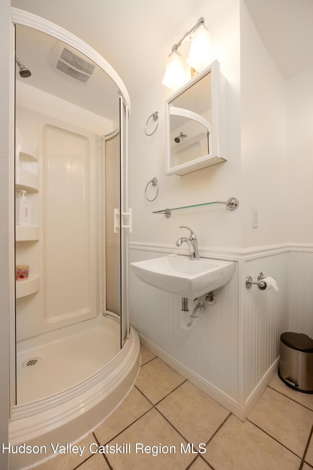 159 Pine Ln, Saugerties, NY 12477 - bathroom with a shower stall, a wainscoted wall, and tile patterned floors
