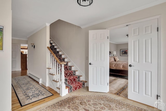 311 County Route 13, Old Chatham, NY 12136 - stairs featuring a baseboard heating unit, ornamental molding, baseboards, and wood finished floors