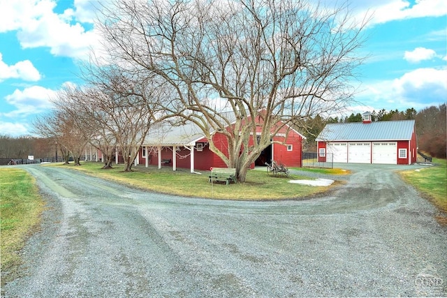 311 County Route 13, Old Chatham, NY 12136 - view of front of home featuring a garage, an outdoor structure, a front lawn, and driveway