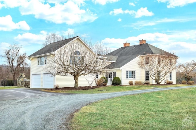 311 County Route 13, Old Chatham, NY 12136 - view of front of house with a chimney, asphalt driveway, an attached garage, and a front yard