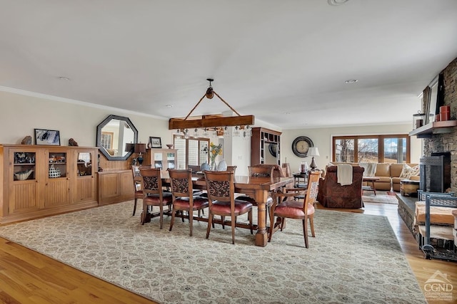 311 County Route 13, Old Chatham, NY 12136 - dining room featuring wood finished floors, a fireplace, and ornamental molding