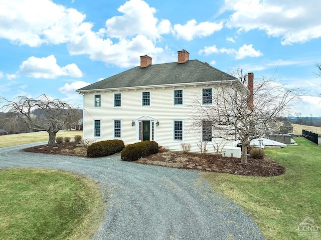 311 County Route 13, Old Chatham, NY 12136 - view of front of house featuring a chimney, a front yard, and driveway