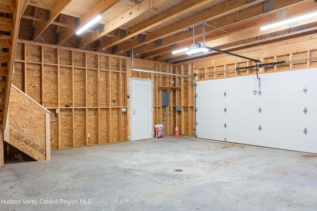 garage featuring a garage door opener and electric panel