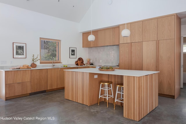 kitchen featuring light countertops, hanging light fixtures, and modern cabinets