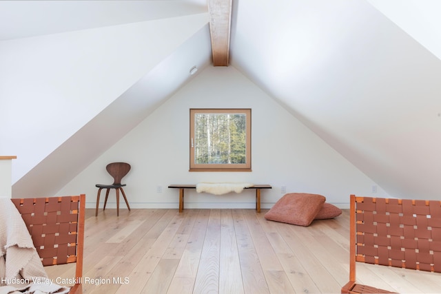 bonus room featuring lofted ceiling with beams and hardwood / wood-style flooring