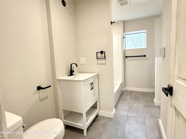 bathroom featuring tile patterned floors, vanity, and toilet