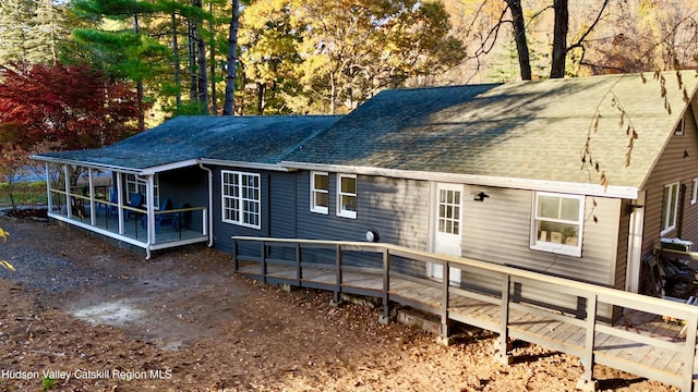 back of property featuring a sunroom and a deck