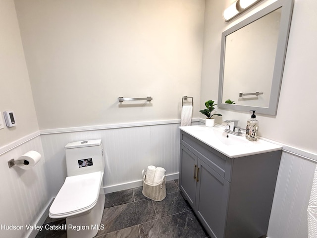 bathroom featuring vanity and toilet