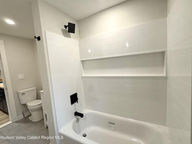 bathroom with tile patterned flooring, tiled shower / bath combo, and toilet