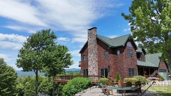 33 Elm Ridge Rd, Windham, NY 12496 - view of home's exterior featuring a chimney and a wooden deck