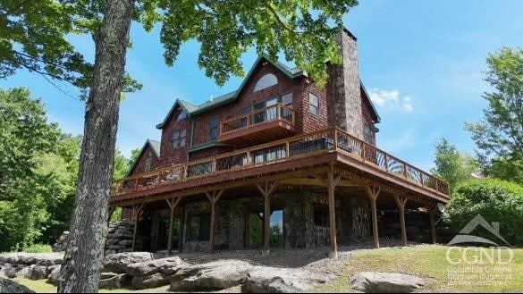 33 Elm Ridge Rd, Windham, NY 12496 - rear view of house with a wooden deck and a chimney