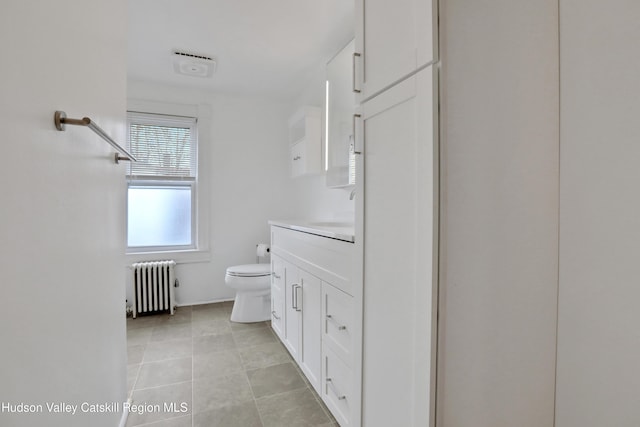 20-22 Milton Ave, Highland, NY 12528 - bathroom featuring radiator, toilet, vanity, and tile patterned flooring
