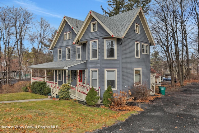 20-22 Milton Ave, Highland, NY 12528 - victorian-style house with a porch, roof with shingles, and a front lawn
