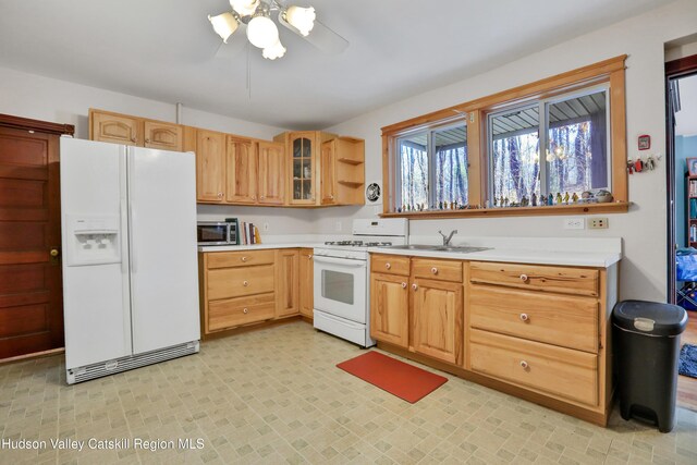 20-22 Milton Ave, Highland, NY 12528 - kitchen featuring white appliances, light countertops, a ceiling fan, glass insert cabinets, and a sink