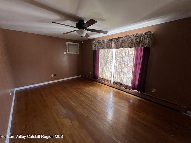 empty room with hardwood / wood-style flooring and ceiling fan