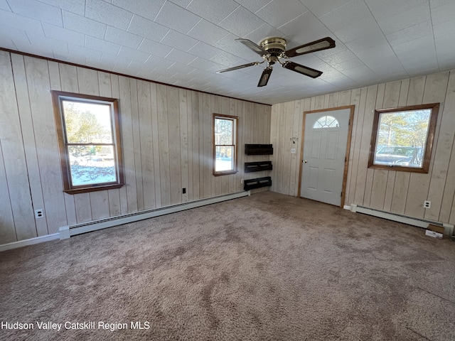 foyer featuring carpet floors, ceiling fan, and a baseboard heating unit