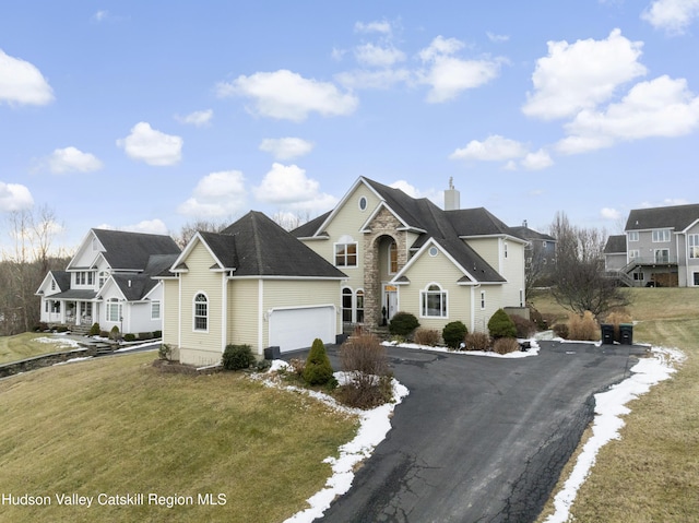 front of property featuring a front lawn and a garage