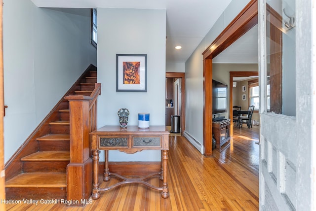 stairway featuring hardwood / wood-style flooring and a baseboard radiator