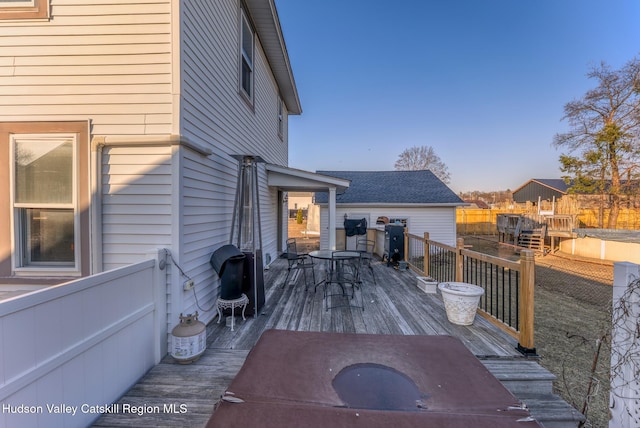 wooden terrace with area for grilling and outdoor dining area