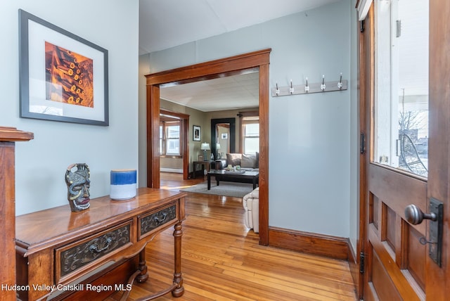 entrance foyer featuring baseboards and light wood-style floors