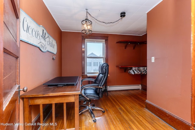 home office with baseboards, baseboard heating, and hardwood / wood-style floors