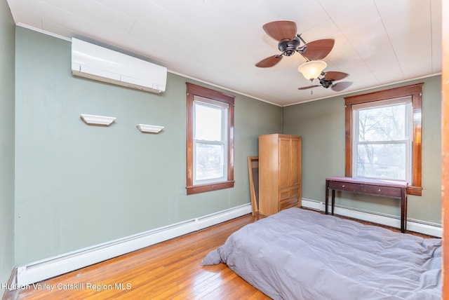 bedroom with a baseboard heating unit, multiple windows, an AC wall unit, and ornamental molding