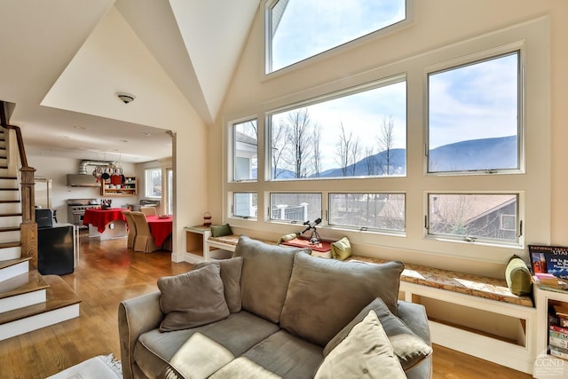 88 Gaby Ln, Hunter, NY 12442 - living area with stairs, wood finished floors, and a towering ceiling