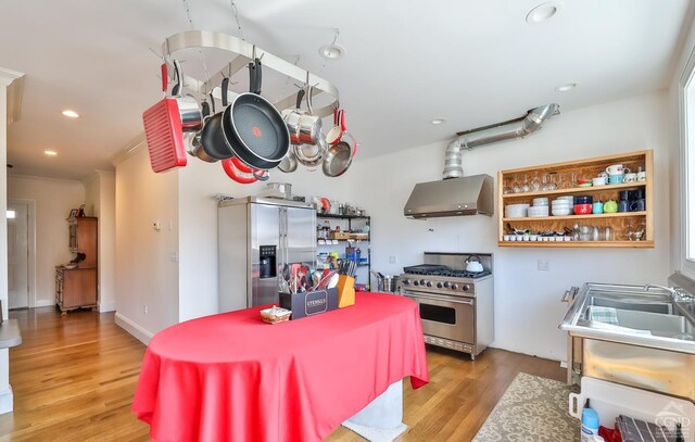 88 Gaby Ln, Hunter, NY 12442 - kitchen with stainless steel appliances, wall chimney exhaust hood, light wood-type flooring, recessed lighting, and open shelves