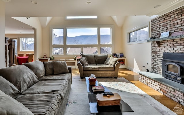 88 Gaby Ln, Hunter, NY 12442 - living room with a mountain view, wood finished floors, a wood stove, and baseboards