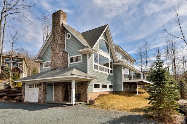 88 Gaby Ln, Hunter, NY 12442 - view of property exterior featuring a chimney, driveway, brick siding, and roof with shingles