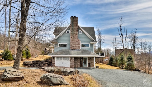 88 Gaby Ln, Hunter, NY 12442 - view of home's exterior featuring driveway, a garage, a chimney, brick siding, and a shingled roof