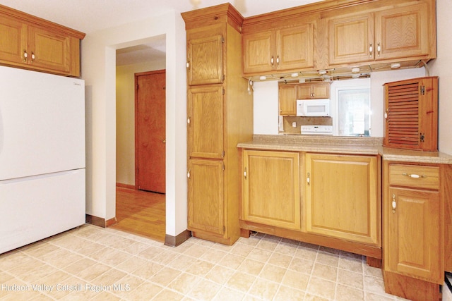 55 Harry Wells Rd, Saugerties, NY 12477 - kitchen with white appliances, light countertops, and baseboards
