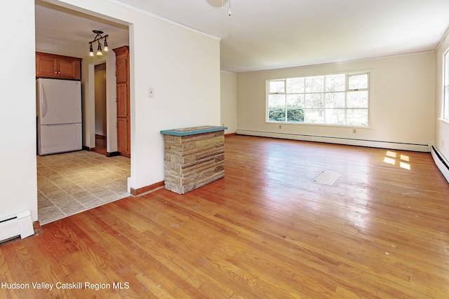 55 Harry Wells Rd, Saugerties, NY 12477 - spare room with light wood-style floors, ornamental molding, baseboard heating, and baseboards