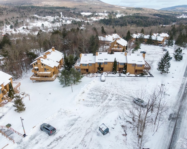 snowy aerial view with a mountain view