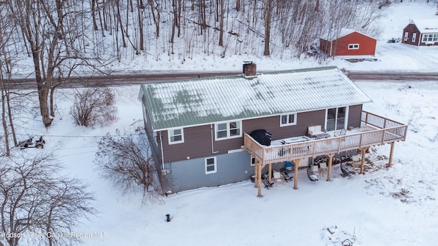 snow covered property featuring a wooden deck