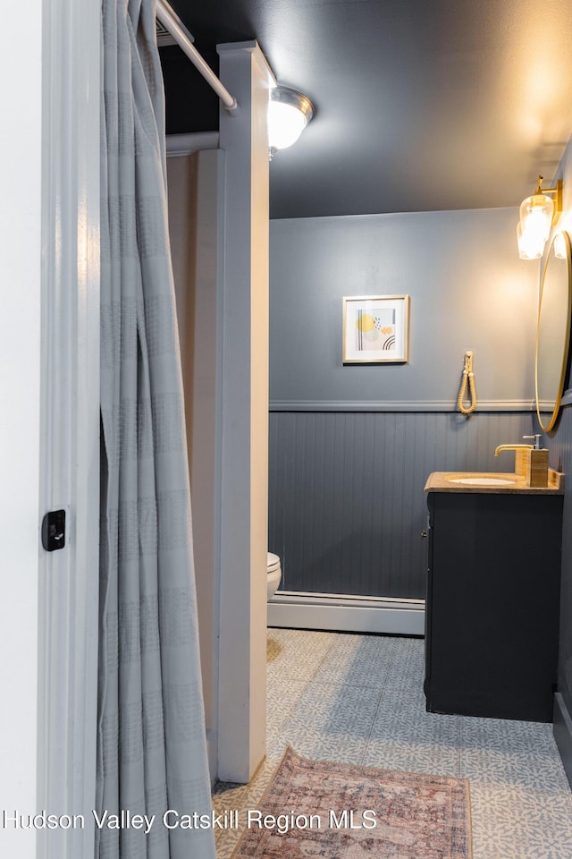 bathroom with vanity and a baseboard heating unit