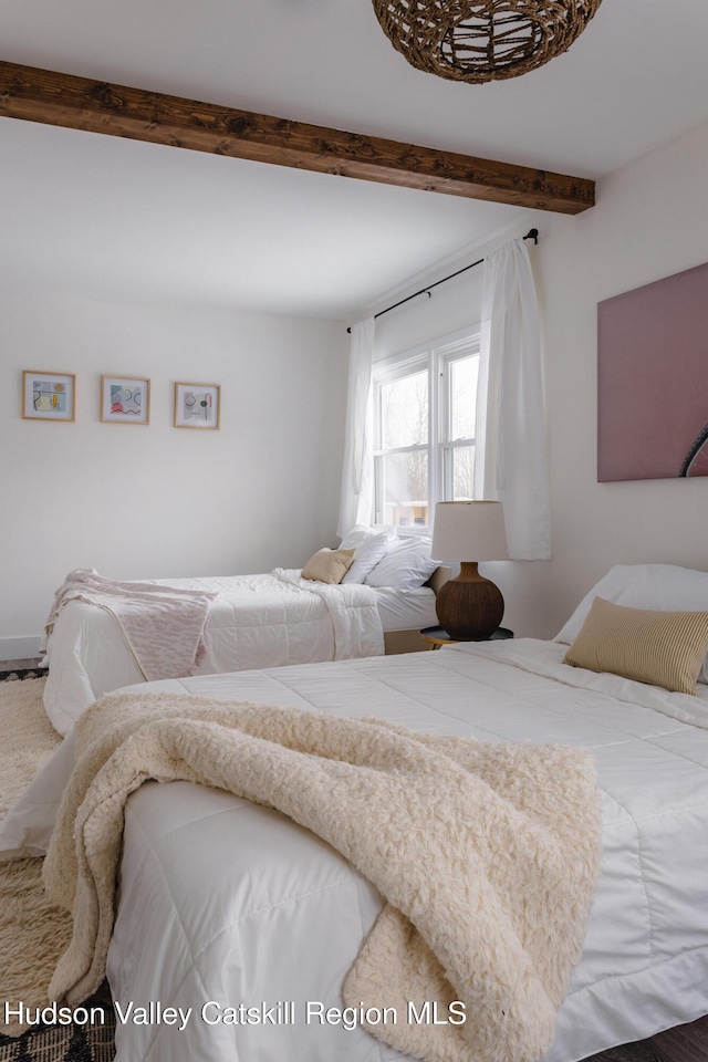 bedroom featuring beam ceiling