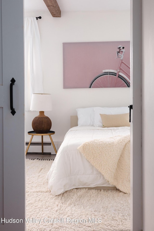 bedroom with beam ceiling and baseboard heating